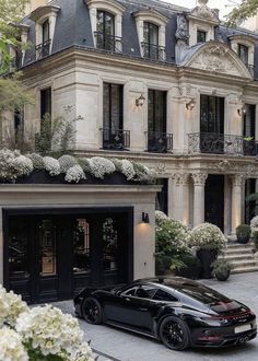 a black sports car parked in front of a building