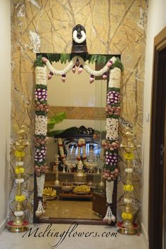 a decorated mirror in the middle of a room with candles and other decorations on it