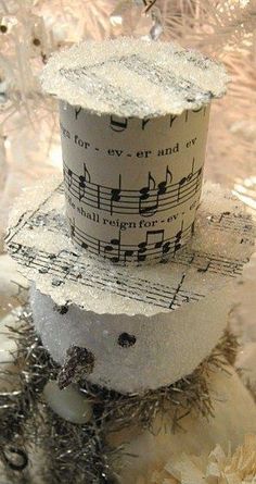 a snowman made out of toilet paper and sheet music notes