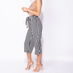 Vertical Striped Pants Self Belt 2 Front Pockets Cropped Wide Leg Fabric Content 95% Polyester 5% Elastane Black Summer Ankle-length Culottes, Chic Cropped Leg Bottoms For Day Out, Chic Cropped Bottoms For Day Out, Summer Cropped Leg Bottoms For Day Out, Chic Striped Bottoms With Elastic Waistband, Spring Capri Bottoms For Day Out, Summer Cropped Leg Capris For A Day Out, Summer Capri Length Bottoms For Day Out, Capri Length Bottoms For Summer Day Out