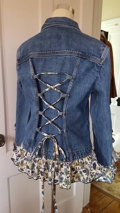 a denim jacket with laces on the back