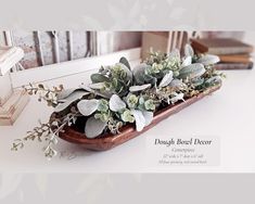 a wooden tray filled with plants on top of a table