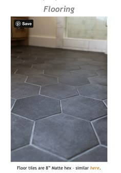 the bathroom floor is made up of hexagonal tiles and gray grouting