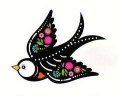 a bird with flowers painted on it's body and wings flying in the air