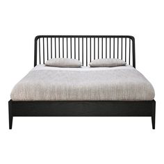 a black bed frame with two pillows on top of it and the headboard is made from wood