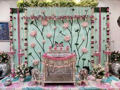 a decorated stage with pink flowers and greenery