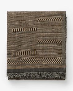 a brown and black woven blanket with fringes