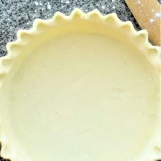 an uncooked pie crust sitting on top of a counter