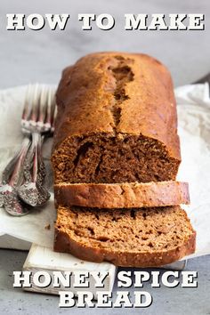 a loaf of bread sitting on top of a cutting board next to a knife and fork