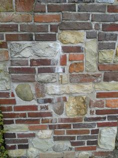 a brick wall with several different colored bricks