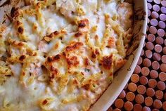 a casserole dish with cheese and chicken on it, ready to be eaten