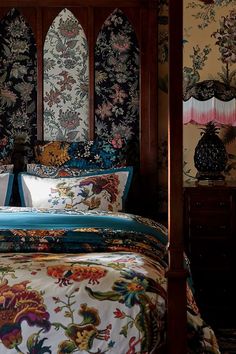 a bed with an elaborately decorated headboard and foot board in front of it