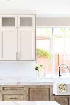 a kitchen with wooden cabinets and white counter tops