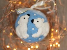 a blue and white ornament with two polar bears on it