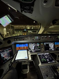 an airplane cockpit with multiple screens and controls