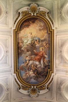 an ornate painting on the ceiling of a building