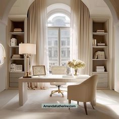 a white desk sitting under a window in a living room next to a book shelf