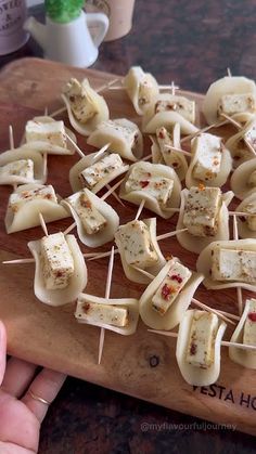 the food is prepared and ready to be eaten on the chopping board with toothpicks