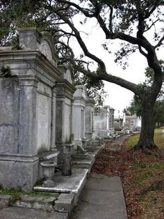 an old cemetery with many headstones and trees