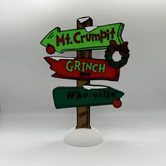 a wooden sign that says mt grumpit grinch who's next?