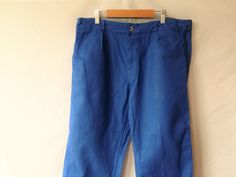 - Vintage workwear pants in blue, French vintage - most probably from the 1960s - button closure at the front.  - two front side pockets, one back pocket - Material: mid weight cotton, sanforized Condition: some very light fading of the fabric, but no holes, stains, discolorations at all.  Size:  Please check measurements below and compare to a garment that fits well: Waist circumference: 34.5 in / 88 cm Length (measured from the top edge of the waistband to the hem): 40 in / 102 cm Inseam/inner Retro Blue Bottoms With Pockets, Vintage Blue Bottoms With Side Pockets, Blue Cotton Work Pants With Pockets, Vintage Blue Cotton Bottoms, Retro Work Pants With Pockets, Vintage Blue Pants With Pockets, Vintage Blue Bottoms With Pockets, Vintage Blue Bottoms With Belt Loops, Vintage Blue Trousers