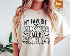 a woman wearing a t - shirt that says, my favorite monsters call me mom