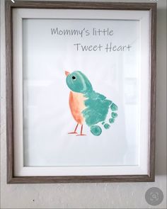 a little bird is painted on the wall in front of a frame with words that read mommy's little tweet heart