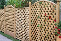 a wooden fence with roses growing on it