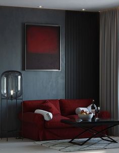 a living room with a red couch and coffee table in front of a painting on the wall