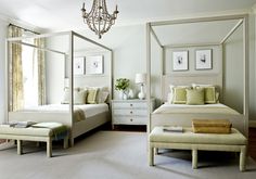 a bedroom with four poster bed and white furniture