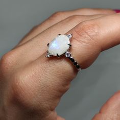 Elevate your style and gift enchantment with our Moonstone Ring This exquisite piece showcases the captivating beauty of moonstone, known for its iridescent play of colors. It's more than a statement piece; it's a meaningful gift that captures the essence of mystique and elegance. 🔸Adjustable band 🔸10mm stone size 🔸Color may vary according to lighting 🔸Silver 925 We offer  🔸Fast shipping  🔸Free shipping for eligible orders  🔸Polishing cloth  🔸Free item on orders of 100€ 🔸Gift box 🎁 🔸Great customer service                                 Moonstone is cherished for its unique ability to shimmer with an otherworldly glow, believed to enhance intuition and provide protection. Its captivating display of colors makes it a timeless choice for jewelry that stands out and carries both be Rainbow Cocktail, Princess Cut Solitaire Ring, Sterling Silver Moonstone Ring, 100 Gift, June Birthstone Ring, Ring Moonstone, Rainbow Moonstone Ring, Moonstone Ring, Ring Silver