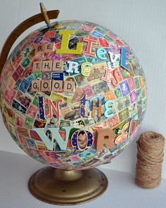 a globe with words all over it and a spool of twine