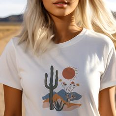 Immerse yourself in the rugged beauty of the West with our Cactus Desert with Wildflowers T-Shirt. This stunning design captures the essence of the desert, featuring a striking cactus landscape adorned with vibrant wildflowers. Crafted in desert-inspired colors, this tee is a perfect choice for those who appreciate the untamed allure of the Western frontier. This Cactus Desert with WildFlowers T-Shirt features a unique and eye-catching design that is perfect for both men and women. Made with high-quality jersey material, this short sleeve tee offers comfort and style. Stand out from the crowd with this one-of-a-kind shirt. #25 Classic unisex jersey short sleeve tee fits like a well-loved favorite. Soft cotton and quality print make users fall in love with it over and over again. Ribbed kni