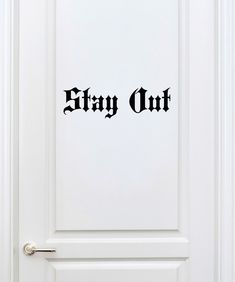 a door with the word stay out on it