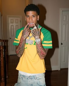 a young man with tattoos on his hands