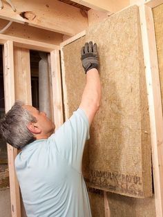 a man working on insulation in a house