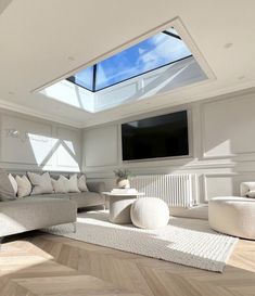 a living room filled with furniture and a flat screen tv mounted to the side of a wall