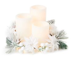 three lit candles surrounded by white flowers and greenery on a white background with snowflakes