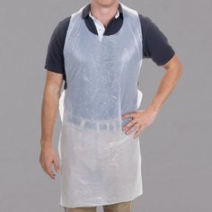 a man in an apron is standing with his hands on his hips and smiling at the camera