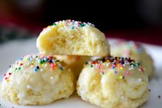 small white cookies with colorful sprinkles on a plate, ready to be eaten