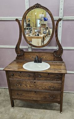 an old dresser with a mirror on top