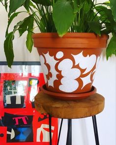 a potted plant sitting on top of a wooden stand