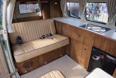 an interior view of a motor home with wood paneling and tan leather upholster