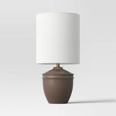 a brown table lamp with a white shade on it