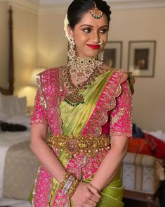 a woman in a pink and green bridal outfit