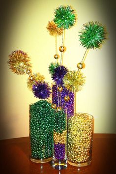 two vases filled with different types of beads and tinsel next to each other