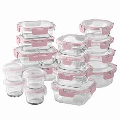 a stack of glass containers with pink lids and lids on each container is shown in front of