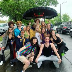 a group of people posing in front of an umbrella