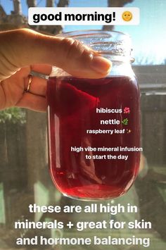 someone is holding up a jar with liquid in it that says, hibicus nettle raspberry leaf high vibe great for skin and hormone balancing