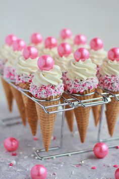 some ice cream cones with pink sprinkles on them